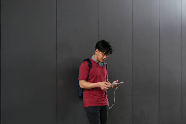 istock Portrait of Asian Boy Student Using a Digital Tablet on Campus 1304731890