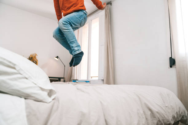 istock Boy jumping on the bed 1304733942