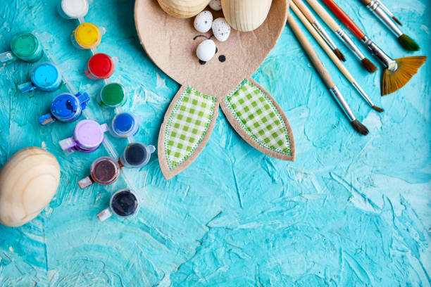 istock Top view pack of eggs with brush, paint and decorative elements 1304737068
