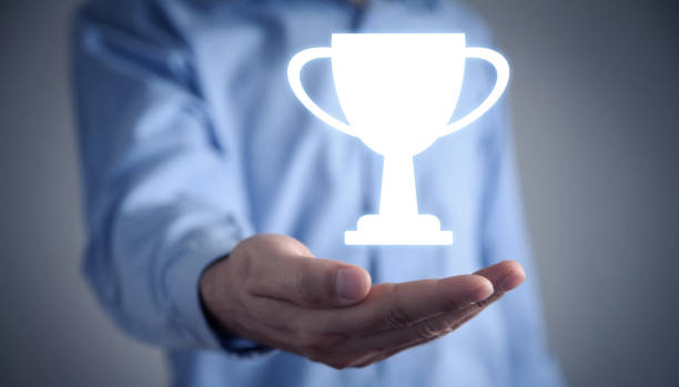 istock Man holding winner trophy cup. Winner. Success 1304738379