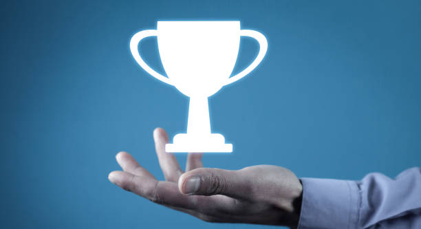 istock Man holding winner trophy cup. Winner. Success 1304738444