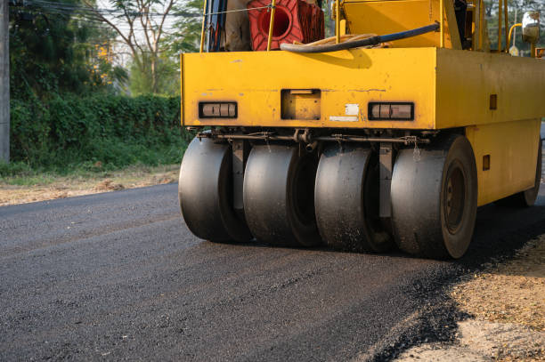istock Heavy vibration yellow steamroller or soil compactor working on hot-mix asphalt pavement road 1304739488