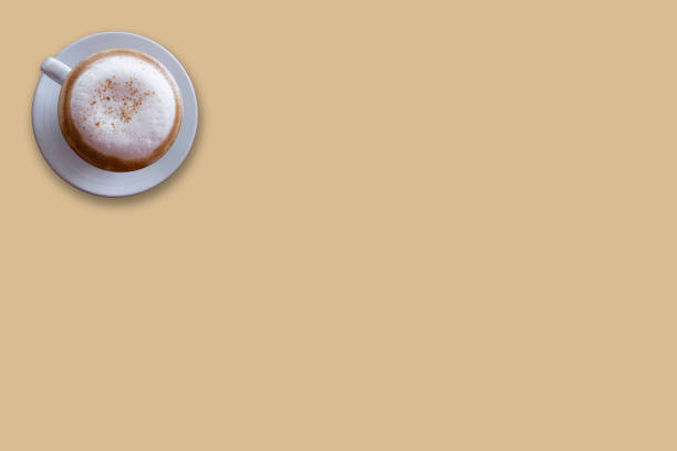 istock Top view of latte, cappuccino coffee in white cup on brow background. With copy space 1304740355