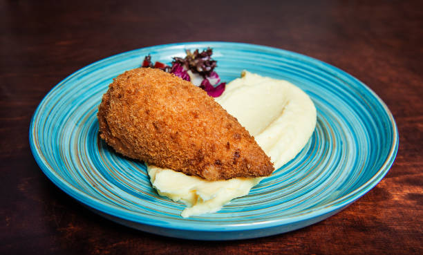 istock Traditional Kiev cutlet with mashed potatoes and salad 1304740444