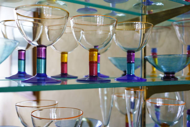 istock Colorful Glasses on Glass Shelf 1304741345