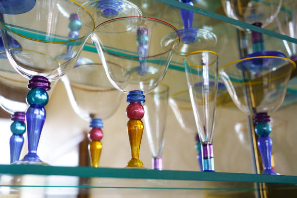 istock Colorful Glasses on Glass Shelf 1304741698