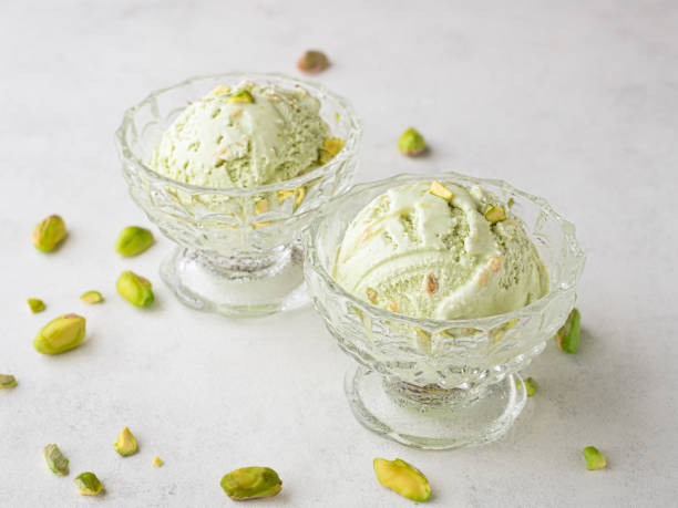istock Pistachio ice cream in glass bowls and nuts 1304741904