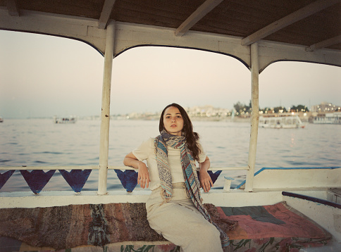 Young Caucasian woman traveling on boat on Nile river