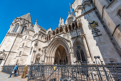 London, UK - June 26, 2018: Royal Courts of Justice building wide angle view exterior architecture with sign in center of downtown city