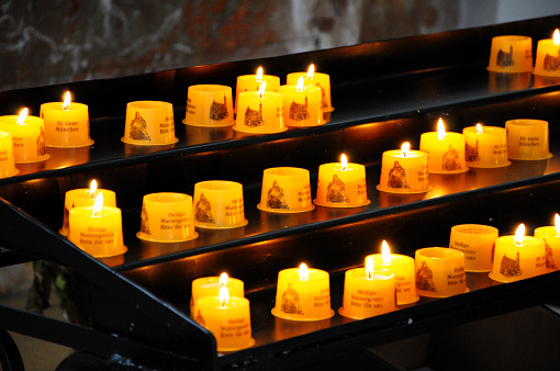 Munich, Germany - AUGUST 03, 2014: Lit candles in the catholic temple in Bavaria. St. Michael Kirche.
