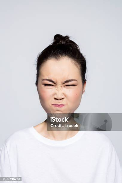 Asian Young Woman Blowing Cheeks Stock Photo - Download Image Now - Embarrassment, Human Face, Disgust