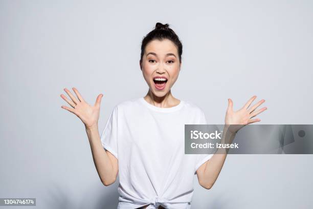 Excited Young Woman Screaming At Camera Stock Photo - Download Image Now - Women, T-Shirt, Only Women