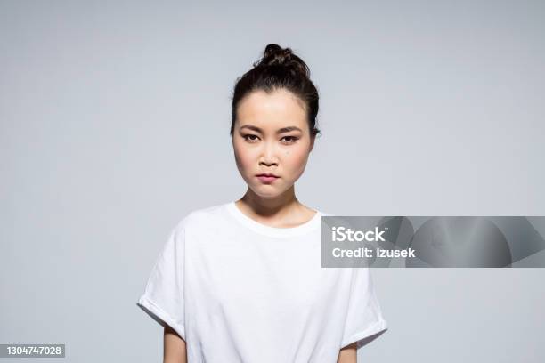 Headshot Of Angry Asian Young Woman Stock Photo - Download Image Now - Portrait, Irritation, Frustration
