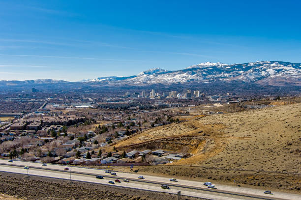Reno, Nevada USA - February 28, 2021: Aerial view City of Reno Nevada cityscape showing the downtown skyline with Hotels, Casinos and the surrounding residential area with snow capped mountain background.