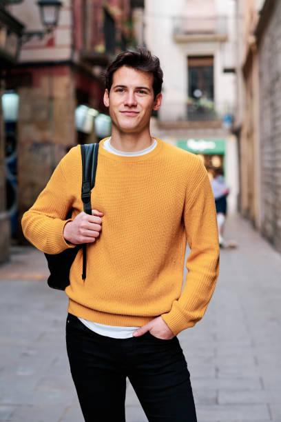 istock Young man with a backpack standing outdoors on the street. 1304747398
