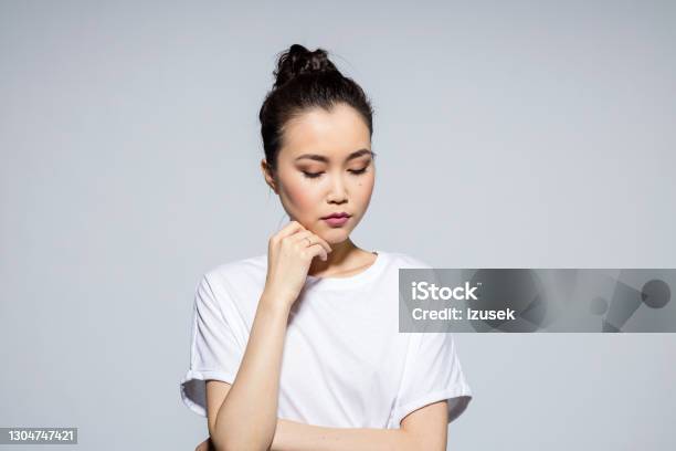 Pensive Beautiful Asian Young Woman Stock Photo - Download Image Now - Women, Sadness, One Woman Only