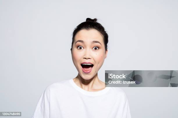 Surprised Young Woman Staring At Camera Stock Photo - Download Image Now - Shock, Fashion Model, Asian and Indian Ethnicities