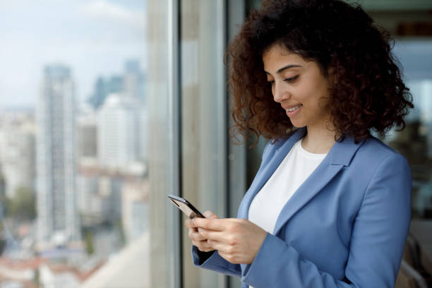 istock Young businesswoman using smart phone in office 1304748683