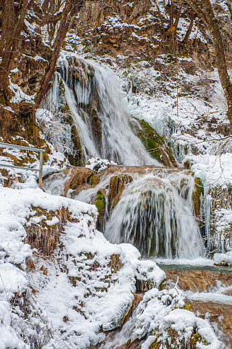 Beautiful frozen Gostilje waterfall in mountain Zlatibor, Serbia