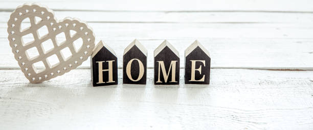 istock Minimalistic composition with decorative word home and decorative heart close up. 1304748845