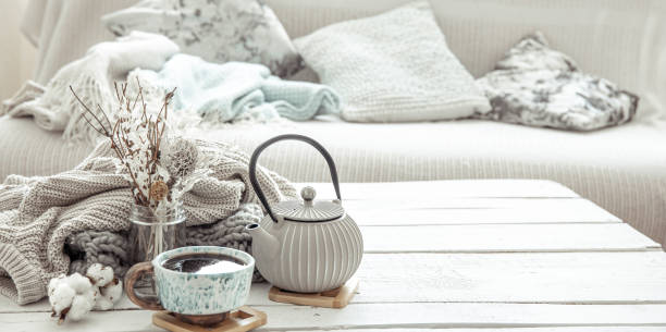 istock Cozy Scandinavian composition with teapot, ceramic cup of tea and decor details copy space. 1304748849