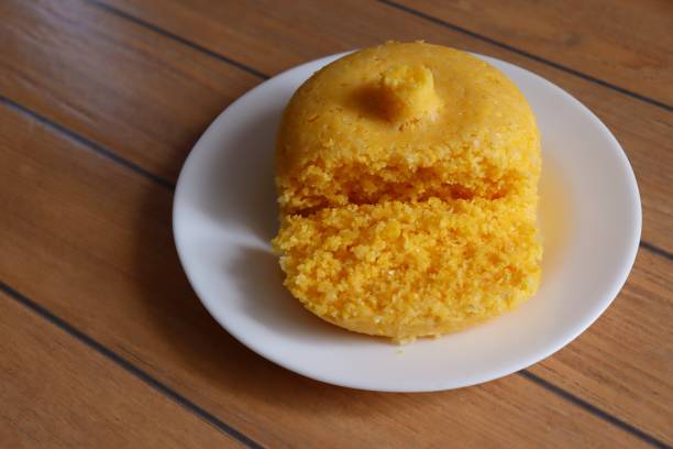 istock Brazilian Couscous (Cuscuz Brasileiro) on wooden background. 1304750107