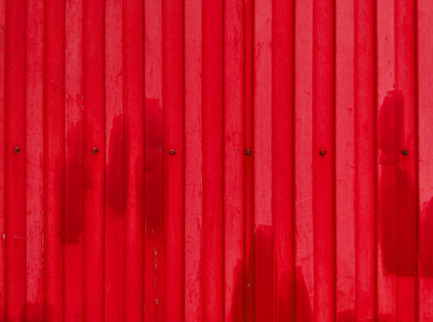 istock Red rippled metal texture with bolts and rivets 1304755079