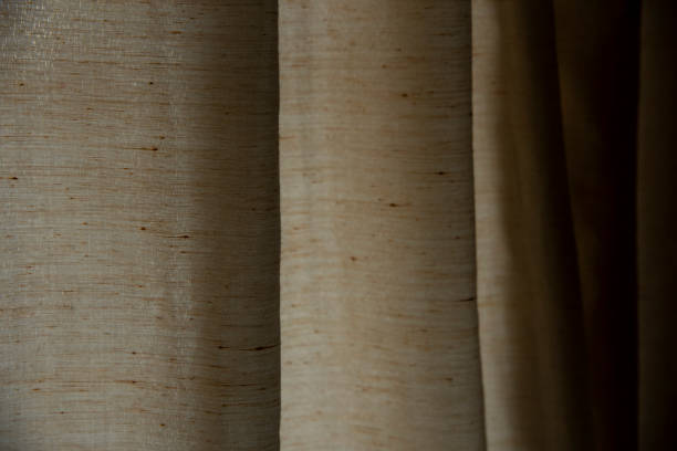 istock selective focus shot of beige and brown curtains texture background 1304755960