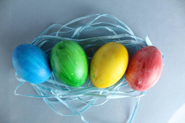 istock Easter background multicolored painted eggs blue green yellow red on a light blue background with a place to text the view from above with a copyspace 1304756452