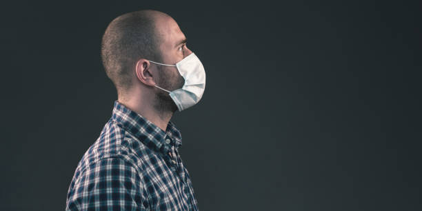 istock The guy in a blue protective medical mask. Virus protection 1304756675