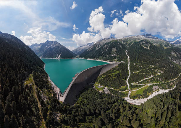 Aerial panorama of Schlegeis Stausee reservoir dam and panoramic Alpine Road in the Zillertal Alps, Tirol, Austria. Wide angle aerial of Schlegeis Stausee dam, Austria. zillertaler alps stock pictures, royalty-free photos & images