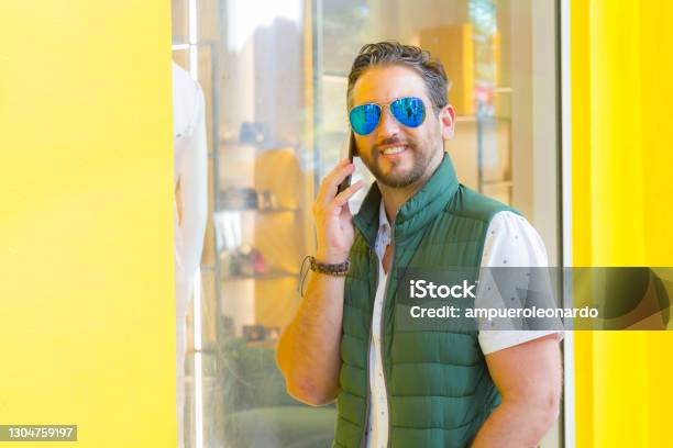 Young Latin Stylish Man Texting By Cellphone In Miami Beach Florida Usa Stock Photo - Download Image Now