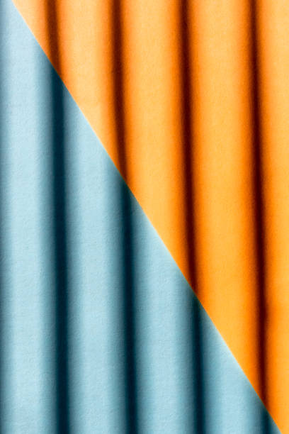 istock Abstract background from orange and blue color with shadows on it 1304759917