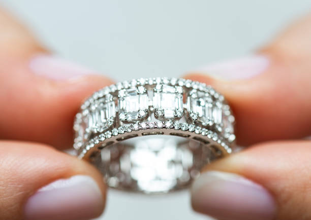 istock Woman Holding A Diamond Ring 1304760482