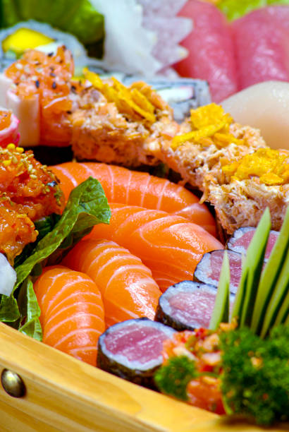 istock Sushi sashimi set in a wooden boat on a brown 1304761373