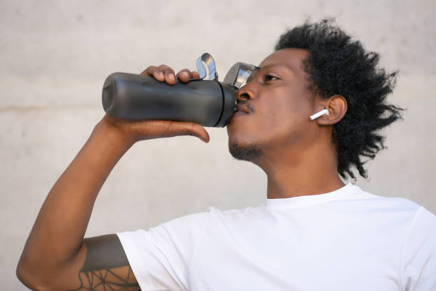 istock Athletic man drinking water after work out outdoors. 1304762067