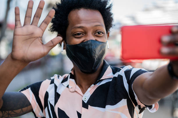 istock Afro tourist man doing video call on mobile phone. 1304762137