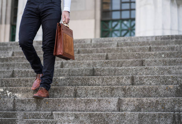 istock Business man holding a briefcase. 1304762171