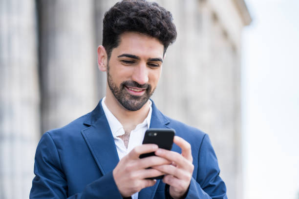 istock Business man using his mobile phone outdoors. 1304762176