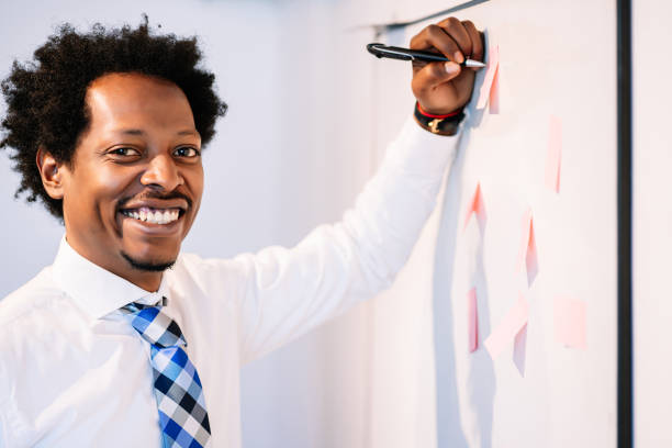 istock Businessman using sticky notes on business meeting. 1304762214