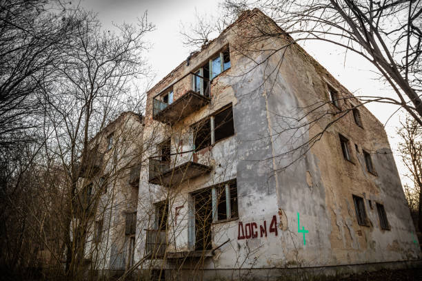 Tab, Hungary - February 24, 2021: Hungarian aged lost place in the forest. Ex soviet, abandoned army base barracks and associated buildings, soldiers family flats and apartments, supermarket shop.