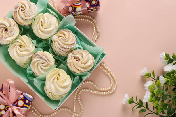istock Homemade zephyr or marshmallows in a box on a pink background, horizontal orientation 1304763694