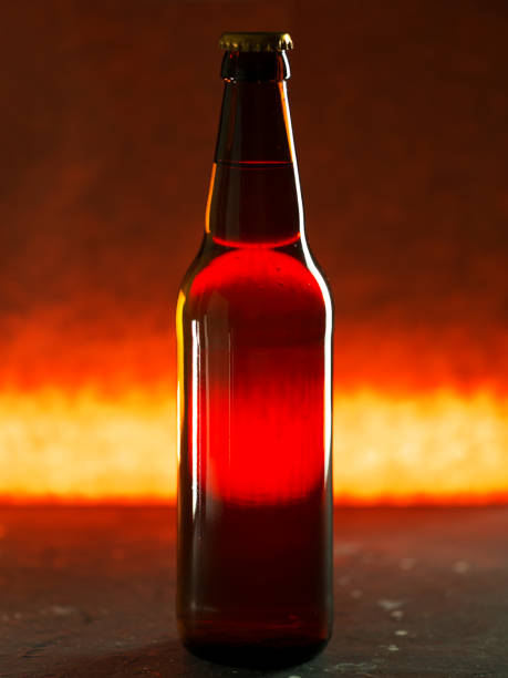 istock Glass beer bottle close-up on back-lit background 1304764542
