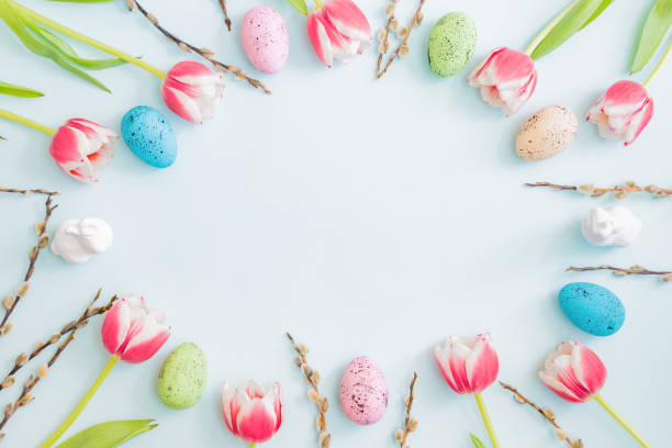 istock Flat lay easter composition with pink tulips and eggs on color background 1304765051