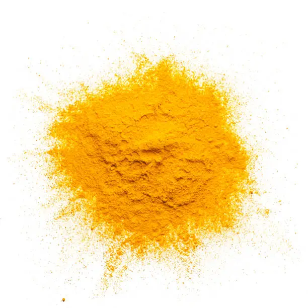 Spices: overhead view of fresh organic turmeric powder heap isolated on white background. Predominant color 1s yellow. High resolution 42Mp studio digital capture taken with Sony A7rII and Sony FE 90mm f2.8 macro G OSS lens