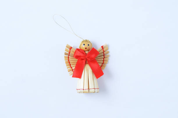 istock Christmas decoration straw angel with red bow on a white background. 1304767099