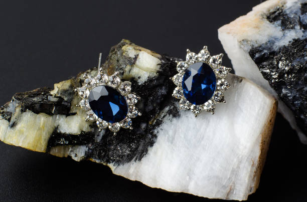 istock Silver earrings with blue stone on natural stone 1304767306