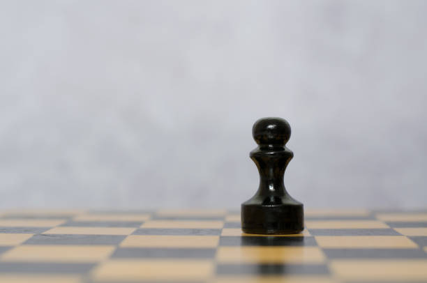 Black chess pawn stepping out from white pawn. Taking risk concept.