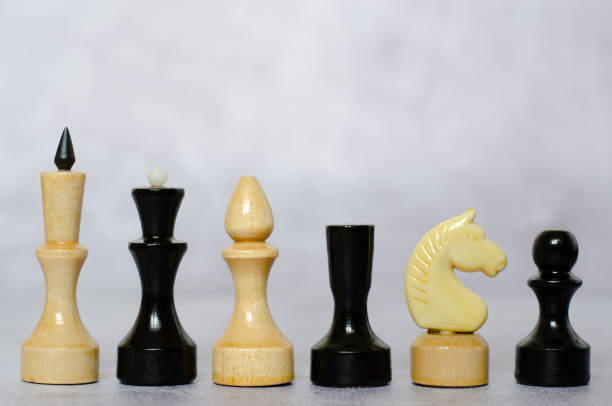 istock Side view of black and white chess pieces on a chessboard 1304767324
