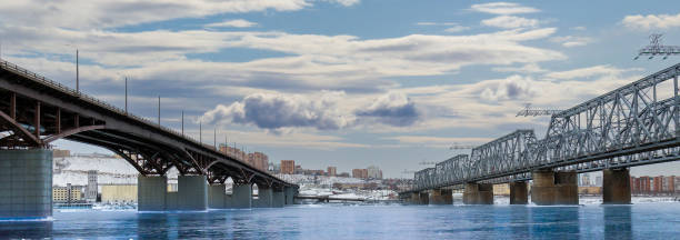 view of the city bridges in the winter Winter view of the city bridges over the Yenisei river in Krasnoyarsk, Russia. Translation: Siberia krasnoyarsk photos stock pictures, royalty-free photos & images